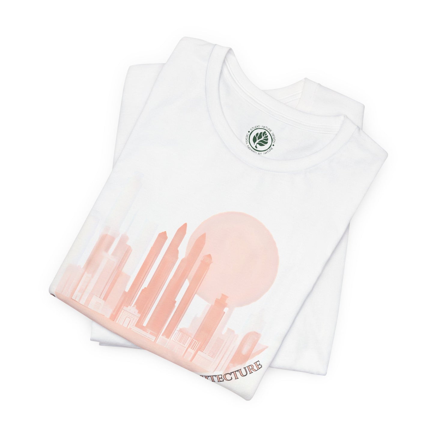 Folded unisex white t-shirt featuring a coral city skyline with the text “Ghosts Drift Through Architecture” beneath, symbolizing poetic urban design.