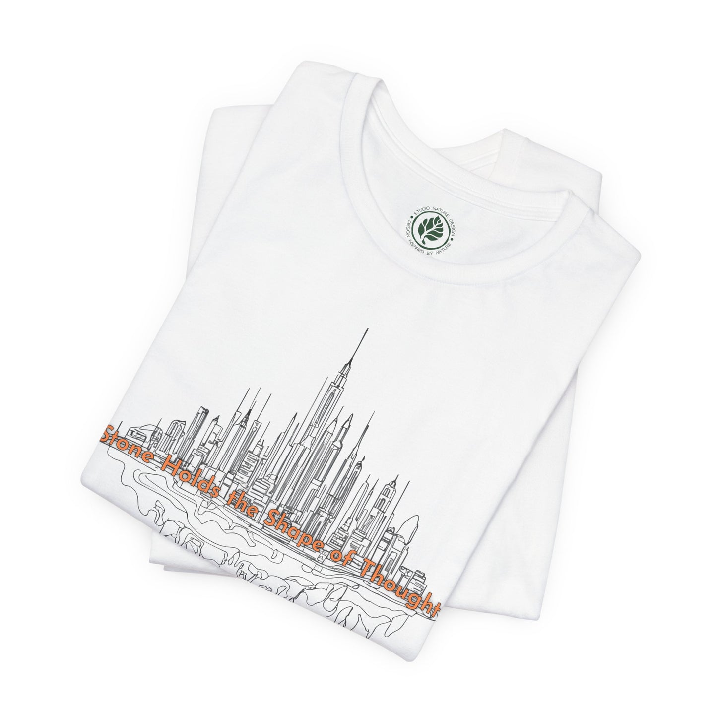 White folded t-shirt with a urban skyline lineart graphic tee inspired by architecture and city life on a white background, by Studio Nature Design brand