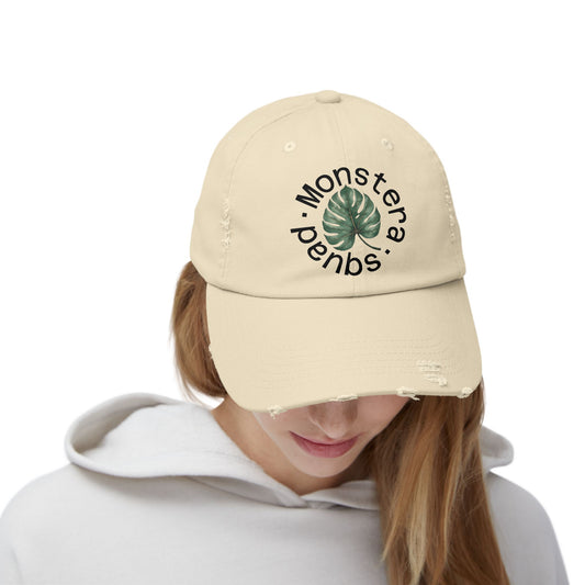 Vintage-style distressed cap embroidered with a Monstera leaf design, perfect for plant lovers and botanical style fans