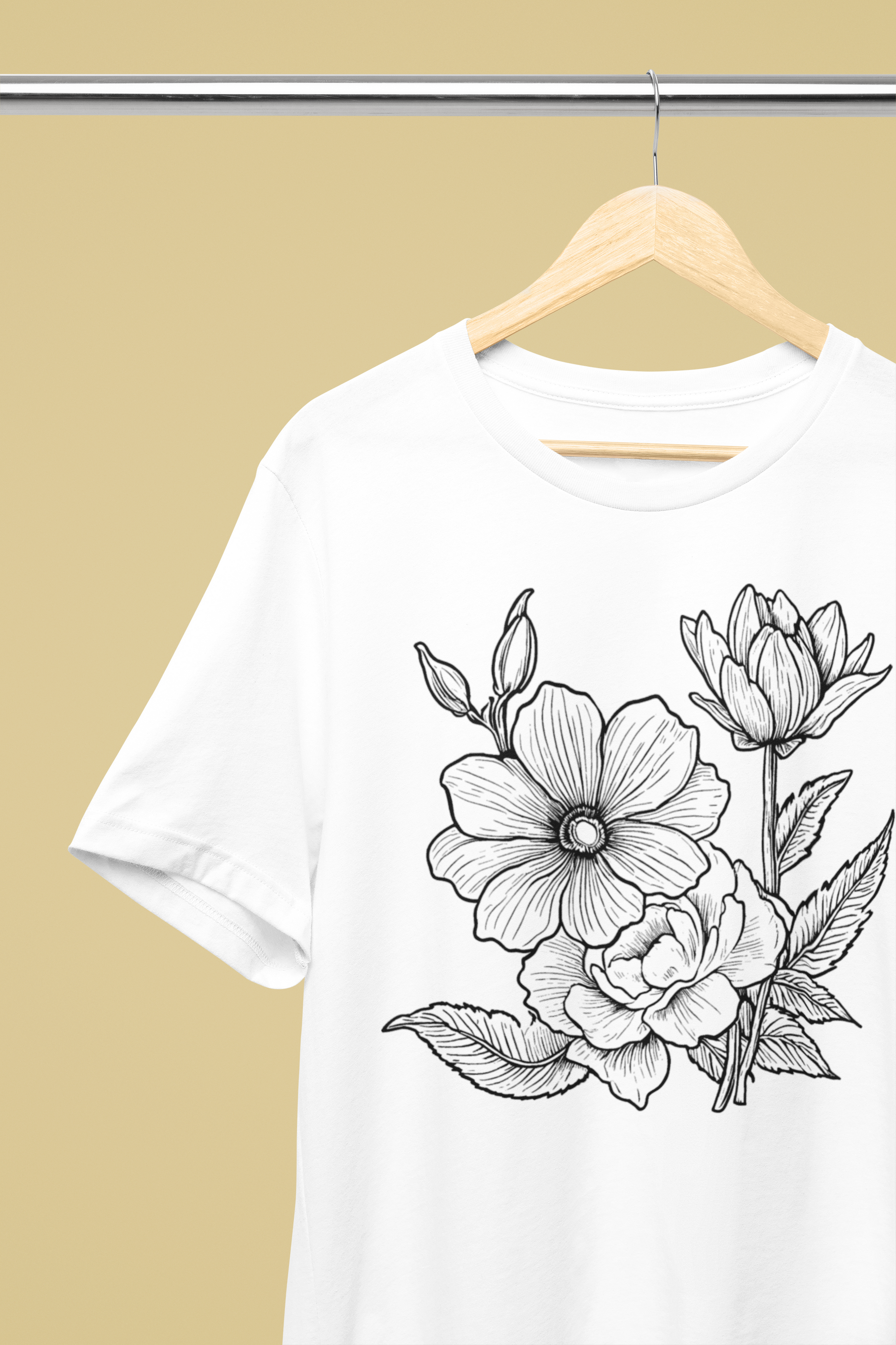 White t-shirt with black floral design on a beige background