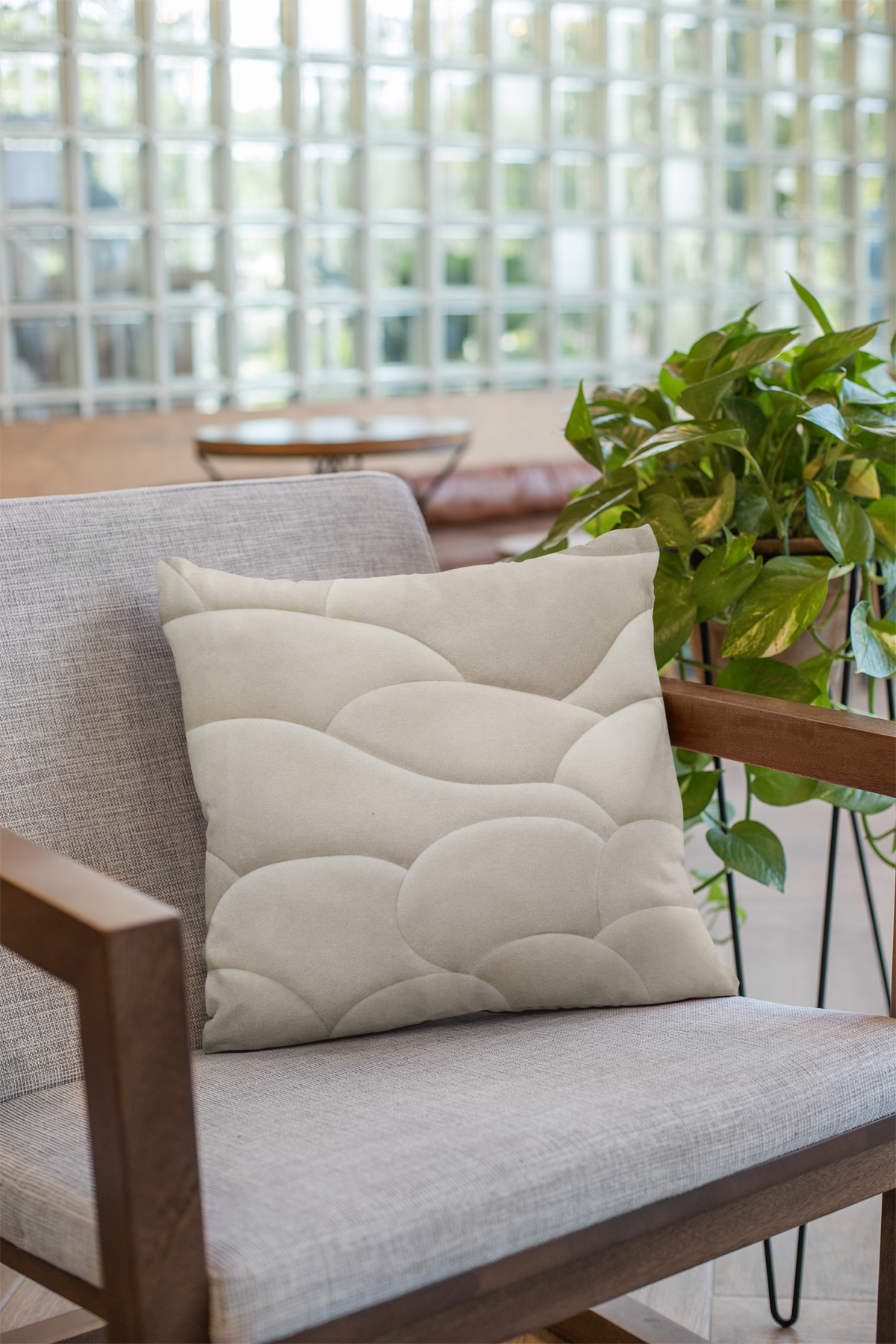 Soft Topography No. 01 faux suede pillow on a neutral armchair in a softly lit interior, showing the warm ivory organic pattern.