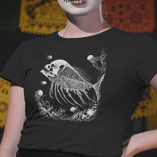 Dark academia inspired black t-shirt with fossilized skeleton fish and skull graphic, perfect for gothic fashion enthusiasts.