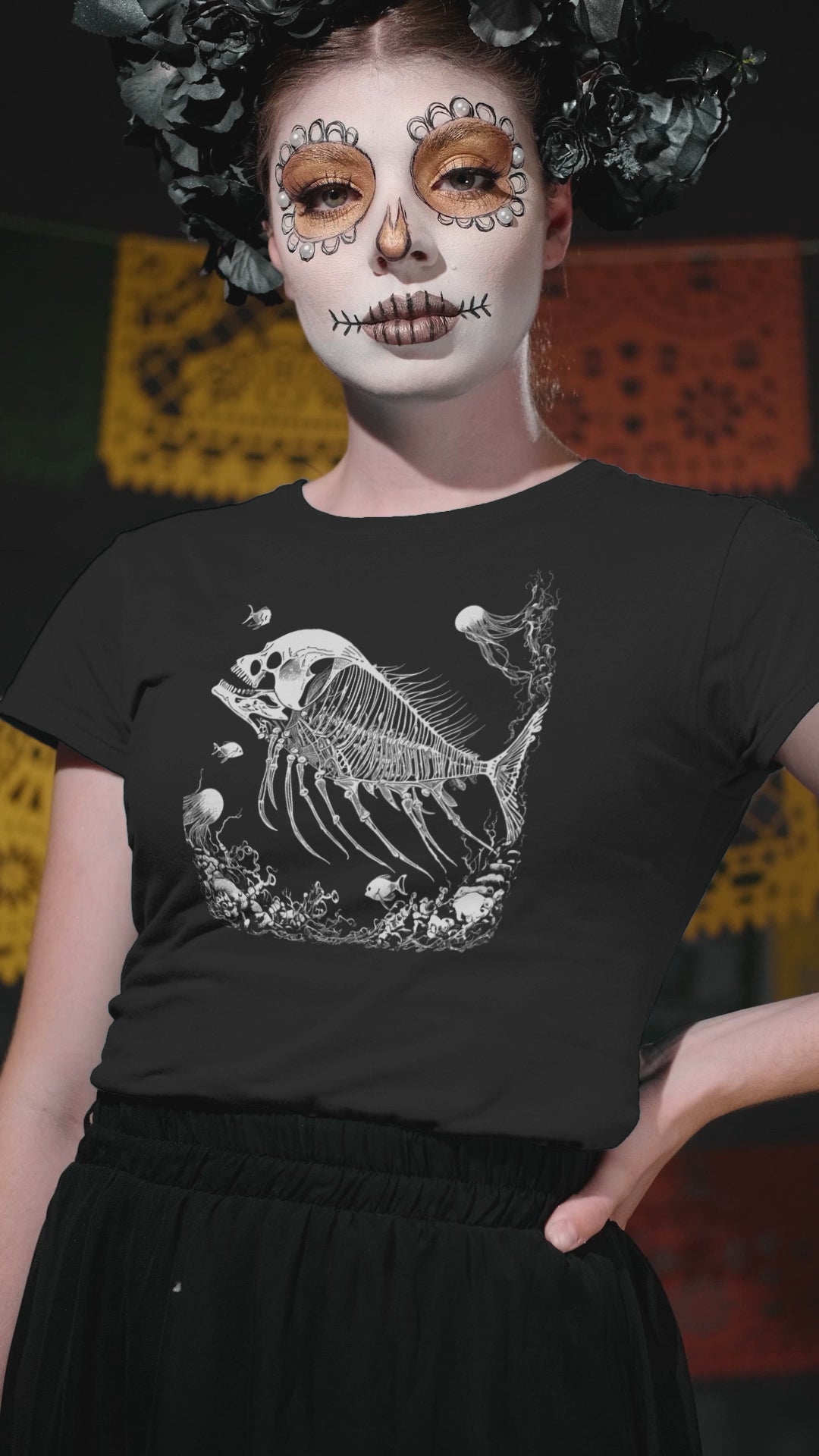 Dark academia inspired black t-shirt with fossilized skeleton fish and skull graphic, perfect for gothic fashion enthusiasts.