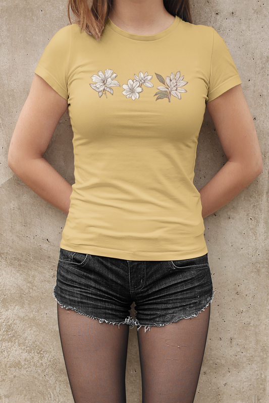 Person wearing a yMinimalist brown flowers T-shirt in botanical print design against a concrete wall.